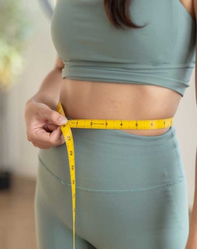 patient measuring waist for medical weight loss