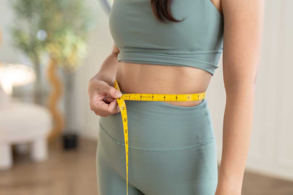 patient measuring waist for medical weight loss