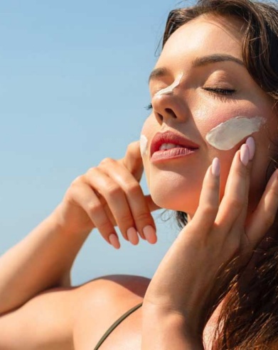 patient using sunscreen to protect skin from sun damage